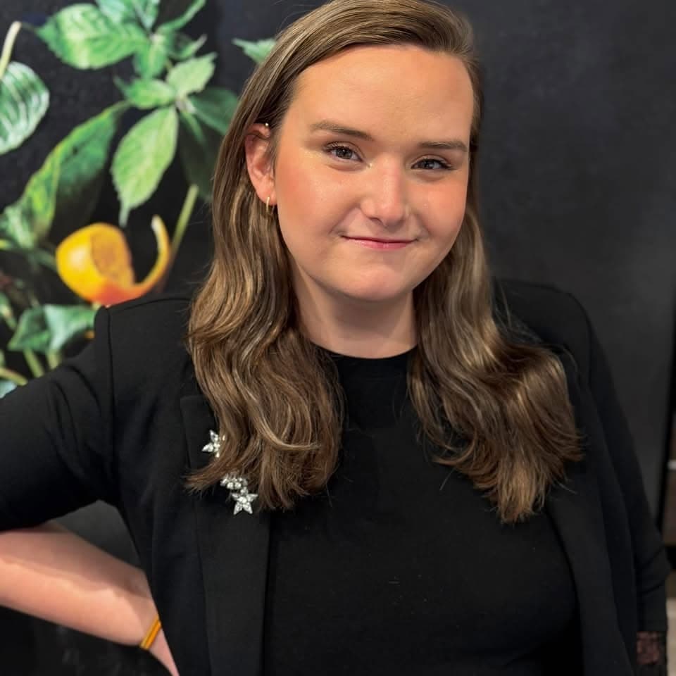 Kobey Laynein a black outfit with greenery in the background